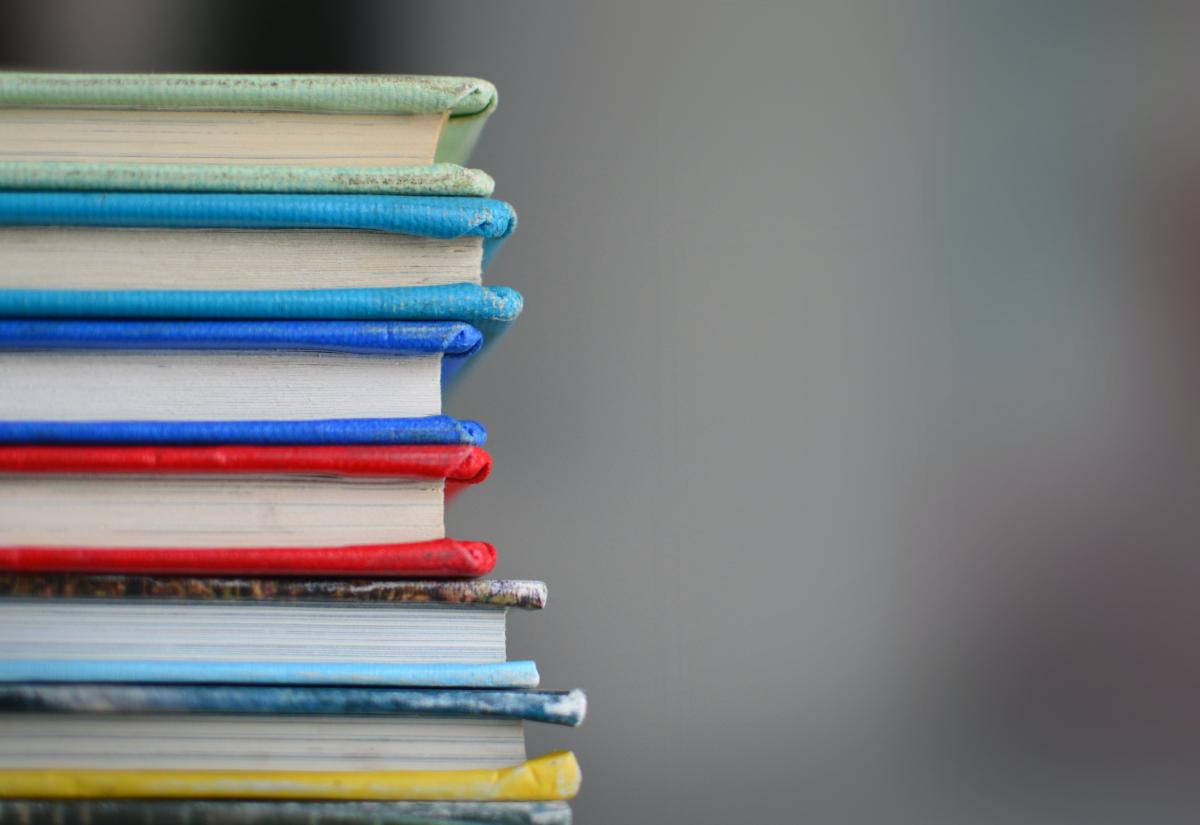 Pile of books. Photo by Kimberly Farmer on Unsplash